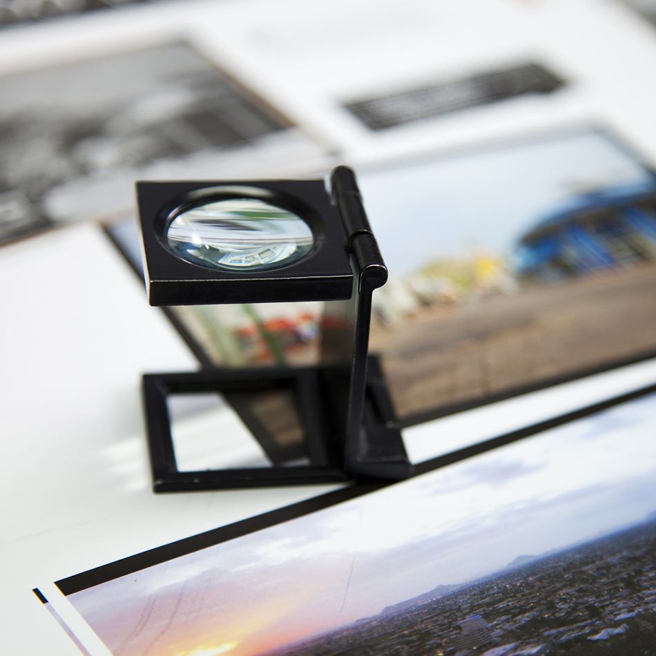 Production Print magnifying glass over photos