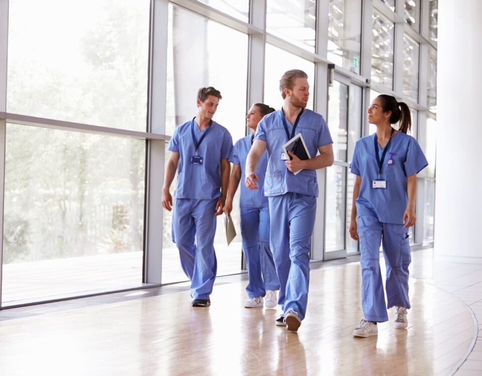 healthcare professionals walking by window