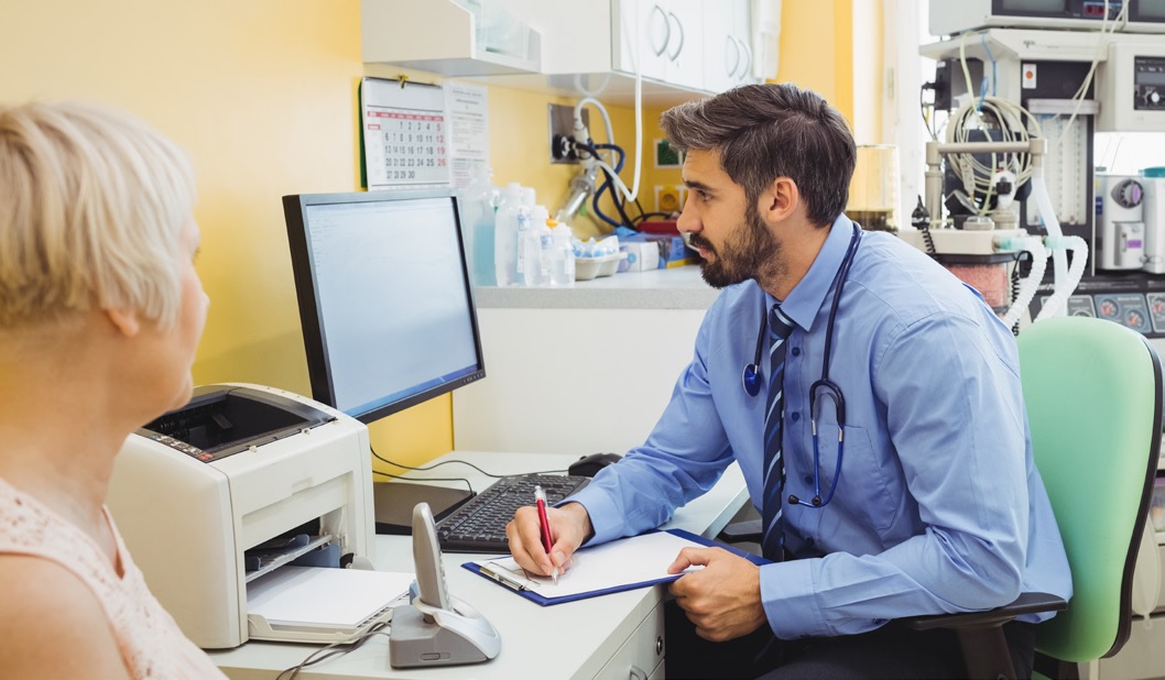 doctor taking notes with a female patient