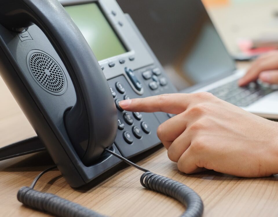 hand dialling an office telephone