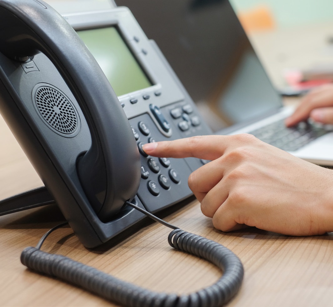 hand dialling an office telephone