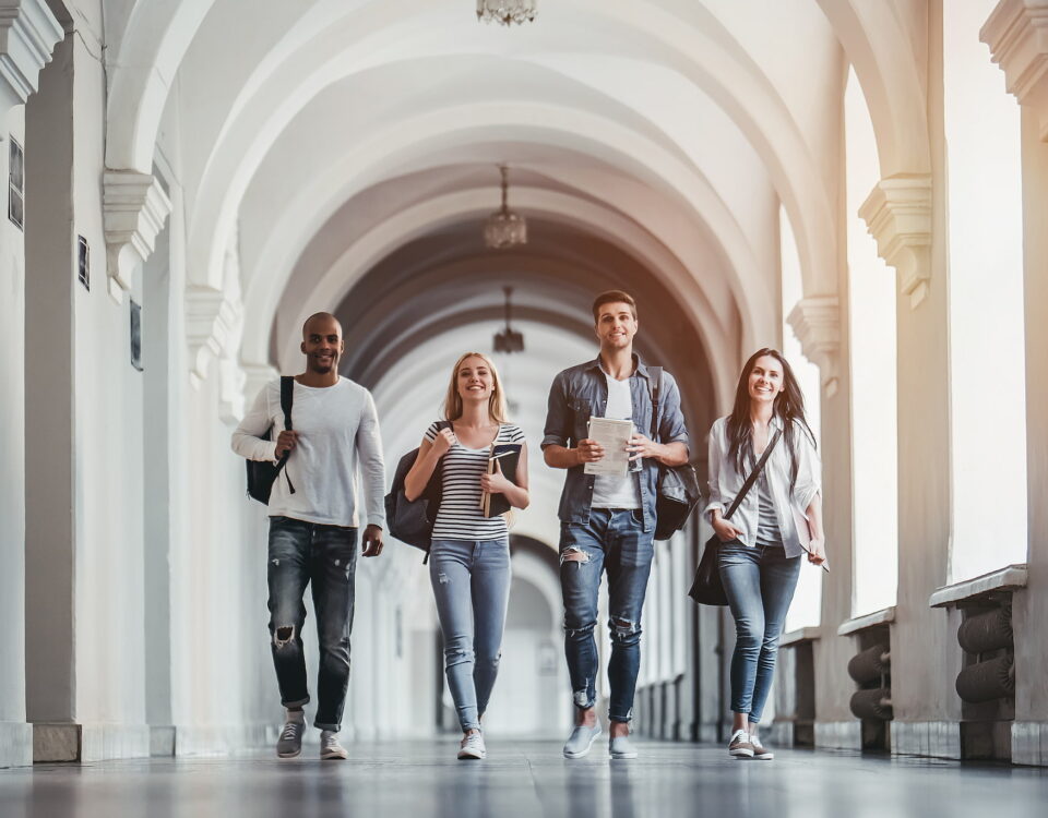 diverse university students walking down corridor