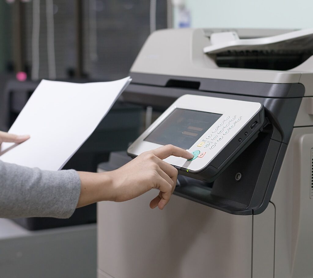 woman using printer photocopier controls