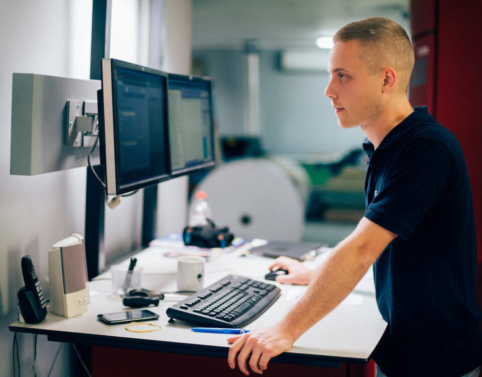young man taking warehouse inventory on computer