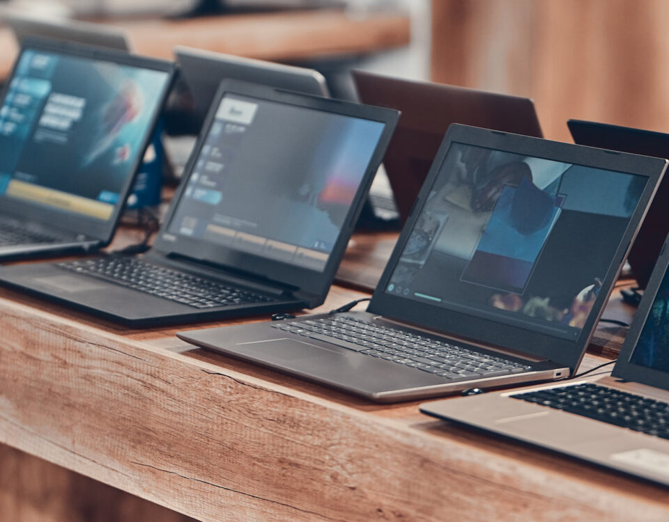 HP laptops arranged on wood table