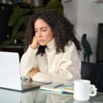 hybrid woman looking frustrated in home office