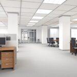 an empty white office with unused desks and chairs