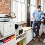 managed print service, man and woman in office chatting, HP printer