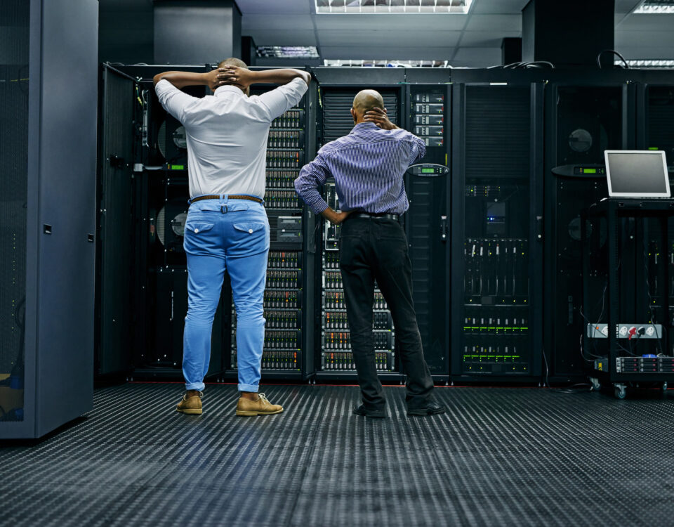 two male stressed it technicians in server room