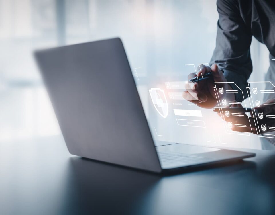 person using laptop on reflective desk