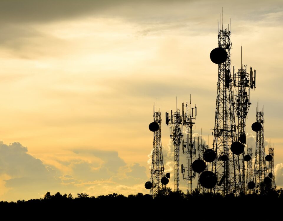 telecoms towers on a hill in the evening