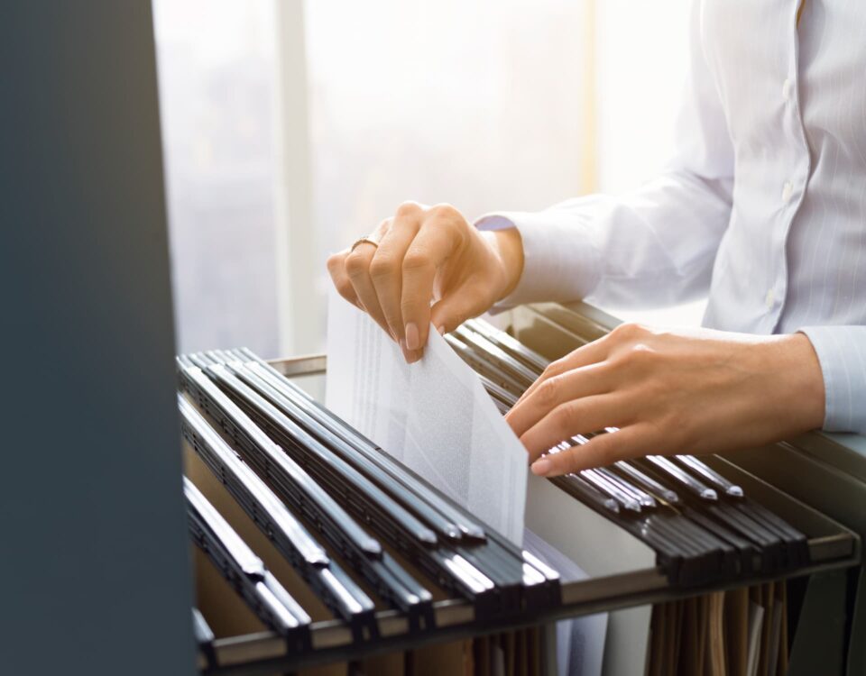 office clerk searching files in the filing cabinet