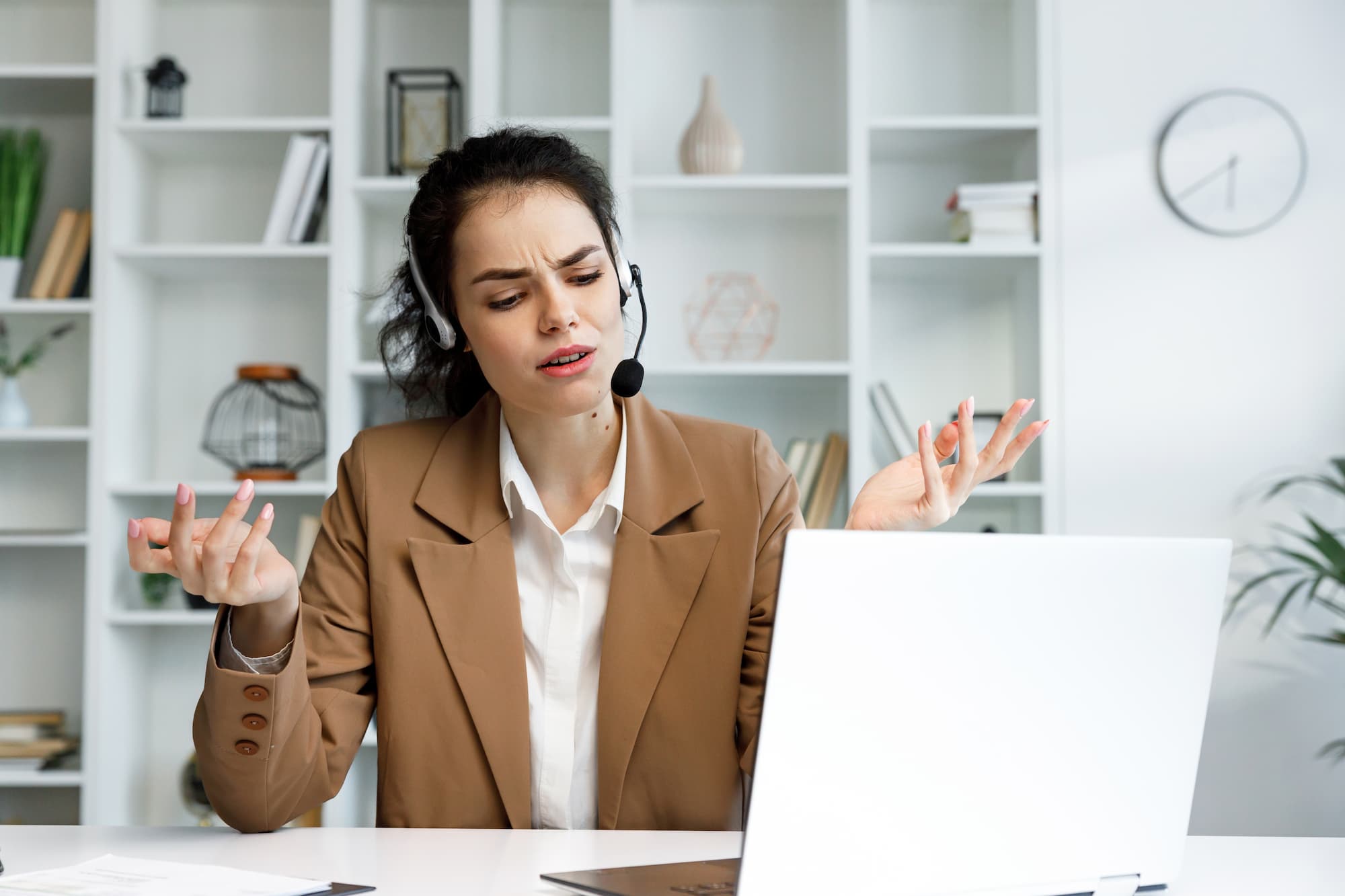 dark haired woman struggling to use headset