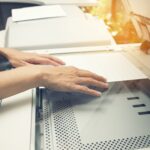 woman scanning a document on an office printer scanner