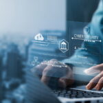 typing on a keyboard with business cyber security network graphic overlay