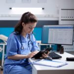 nurse on tablet at computer desk square