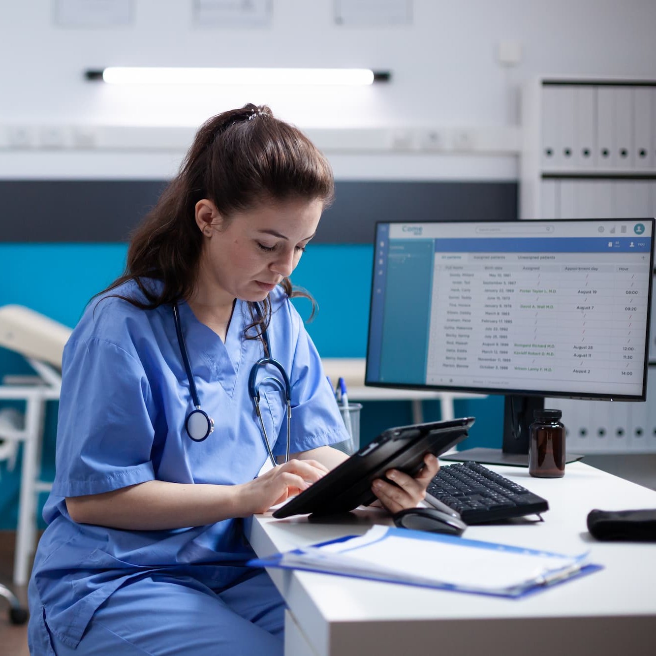 nurse on tablet at computer desk square
